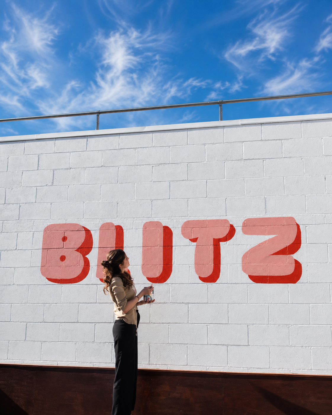 A visitor in front of the Blitz mural wall