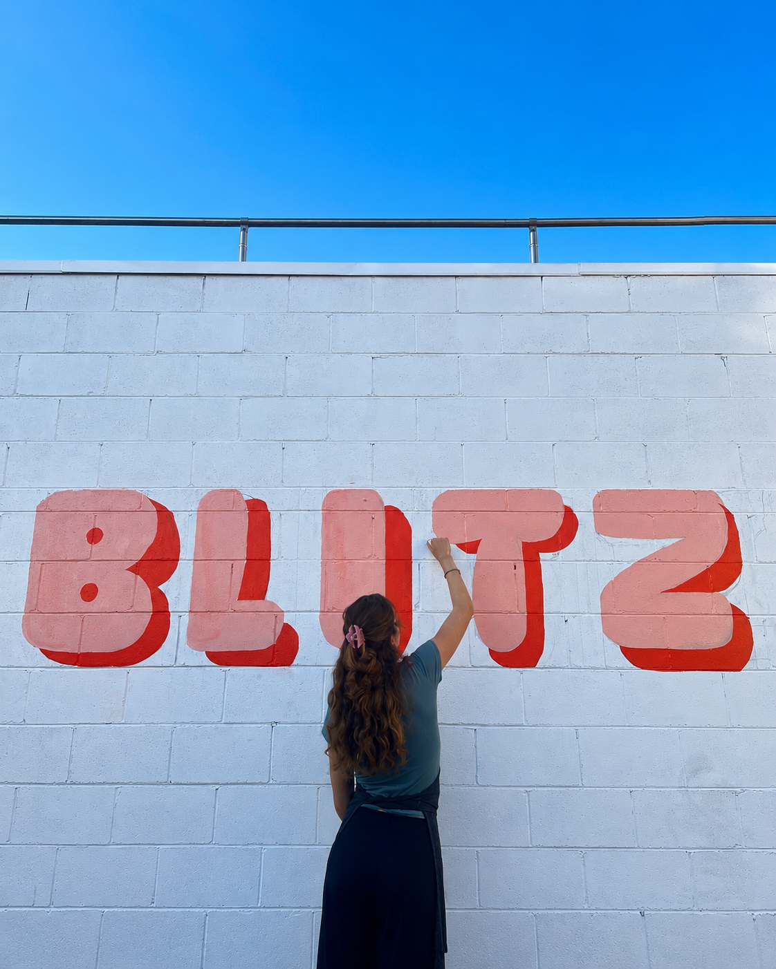 Painting the Blitz mural lettering on the wall